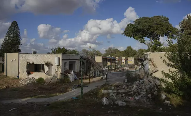 Nearly a year after the deadly Hamas attack Oct. 7, the neighborhood where young people of Kibbutz Kfar Aza used to live remains heavily damaged in the southern Israel border community, Monday, Sept. 16, 2024. (AP Photo/Ohad Zwigenberg)