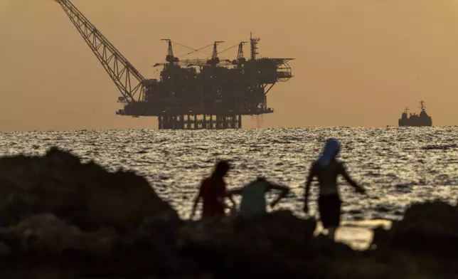 FILE - An oil platform in Israel's offshore Leviathan gas field is seen while an Israeli navy vessel patrols the Mediterranean Sea, Israel, on Sept. 20, 2024. (AP Photo/Ariel Schalit, File)