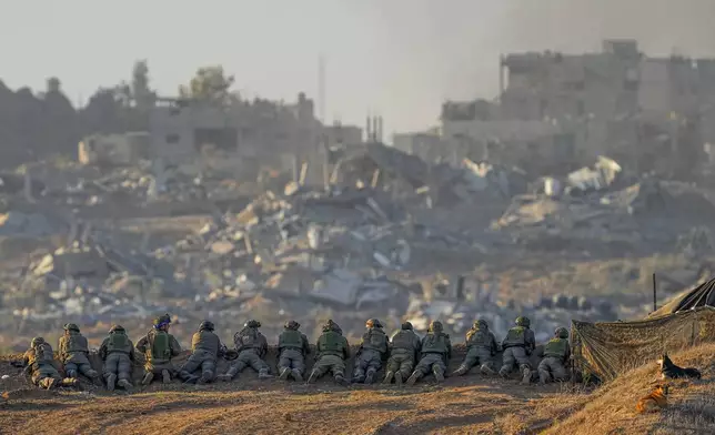 FILE - Israeli soldiers take positions near the border with Gaza in southern Israel, on Dec. 11, 2023. (AP Photo/Ohad Zwigenberg, File)