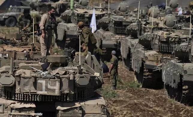 FILE - Israeli soldiers work on tanks in northern Israel on Sept. 27, 2024. (AP Photo/Baz Ratner, File)