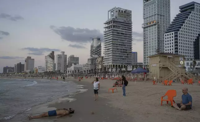 FILE - People at the beach in Tel Aviv, Israel, on Sept. 25, 2024. (AP Photo/Ohad Zwigenberg, File)