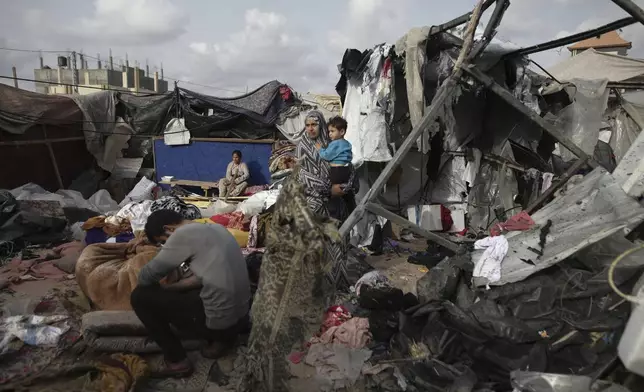 FILE - Displaced Palestinians inspect their tents destroyed by Israel's bombardment, adjunct to an UNRWA facility west of Rafah city, Gaza Strip, Tuesday, May 28, 2024. (AP Photo/Jehad Alshrafi, File)