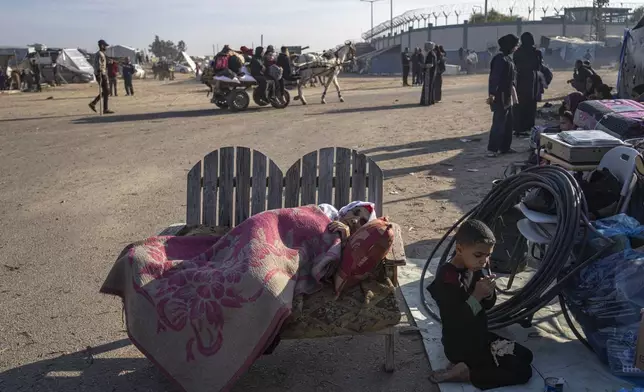 FILE - Palestinians displaced by the Israeli bombardment of the Gaza Strip gather at a tent camp, in Rafah, southern Gaza strip, Monday, Dec. 4, 2023. (AP Photo/Fatima Shbair, File)