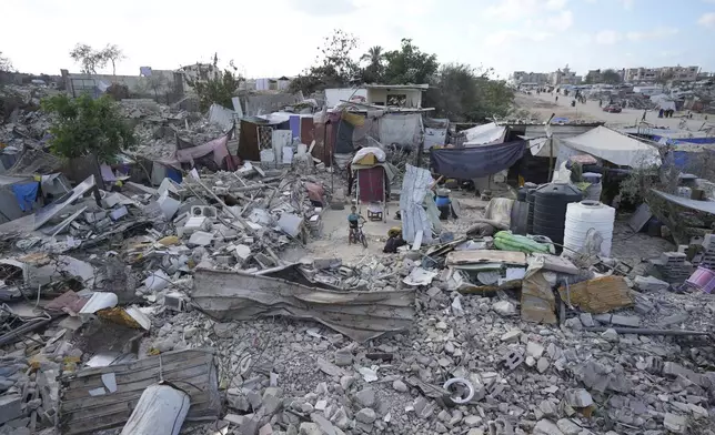 A displaced child stands amidst the debris of a bombed home in Khan Younis, Gaza Strip, Sunday, Sept. 15, 2024. (AP Photo/Abdel Kareem Hana)