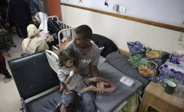 FILE - Abdulrahman Al-Rai holds his daughter Hana Al-Rai, 3, who suffers from diabetes, a weakened immune system and malnutrition at Al-Aqsa Martyrs Hospital in Deir al-Balah in the central Gaza Strip, where she is receiving treatment, on June 1, 2024. (AP Photo/Jehad Alshrafi)