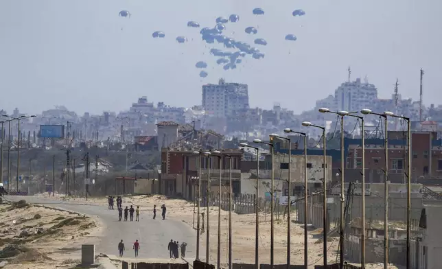 FILE - An aircraft airdrops humanitarian aid over the northern Gaza Strip, as seen from central Gaza, Tuesday, April 30, 2024. (AP Photo/Abdel Kareem Hana, File)