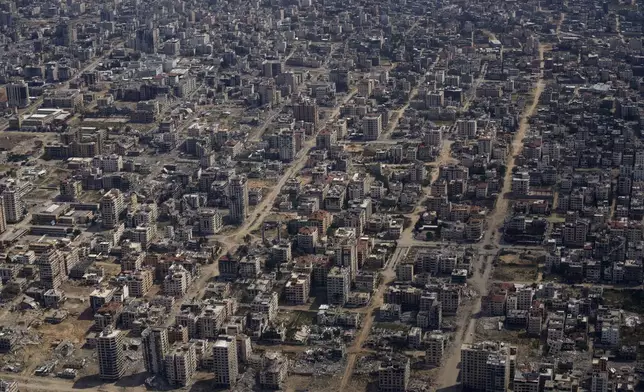 FILE - Destroyed buildings are seen through the window of an airplane from the U.S. Air Force overflying the Gaza Strip, on March 14, 2024. (AP Photo/Leo Correa, File)