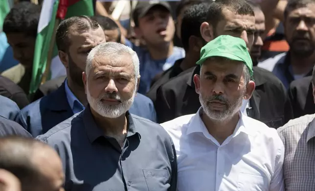 FILE - Head of the Hamas political bureau, Ismail Haniyeh, left, and Hamas leader in the Gaza Strip Yahya Sinwar attend a protest in Gaza City on June 26, 2019. (AP Photo/Khalil Hamra, File)