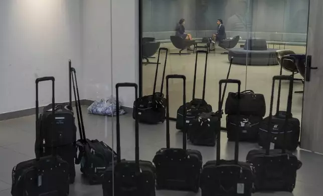 Middle East Airlines hostesses wait for their flights in the operations room at the MEA headquarter in Beirut, Tuesday, Oct. 22, 2024. (AP Photo/Bilal Hussein)