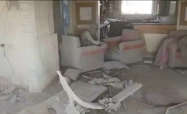 This still image from video provided by the Israel Defense Force (IDF) shows a heavily damaged building with a person the Israeli military identified as Hamas leader Yahya Sinwar seated in a chair in Rafah, Gaza Strip, on Wednesday, Oct. 16, 2024. (Israel Defense Force via AP)