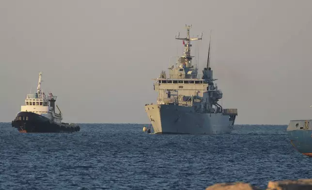 The Italian navy ship Libra, right, arrives at the port of Shengjin northwestern Albania Wednesday, Oct. 16, 2024, carrying the first group of migrants who were intercepted in international waters. (AP Photo/Vlasov Sulaj)