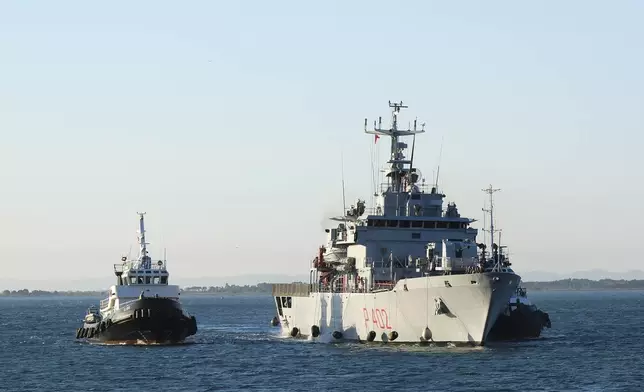 The Italian navy ship Libra arrives at the port of Shengjin northwestern Albania Wednesday, Oct. 16, 2024, carrying the first group of migrants who were intercepted in international waters and redirected to Albania in force of an agreement between the two counties. (AP Photo/Vlasov Sulaj)