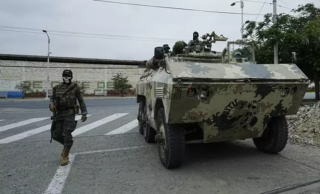 Soldiers patrol in an armored vehicle in Manta, Ecuador, Thursday, Sept. 26, 2024. (AP Photo/Dolores Ochoa)