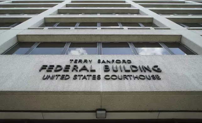 Clouds are reflected in the windows of the federal courthouse in downtown Raleigh, N.C., on Wednesday, July 10, 2024. (AP Photo/Allen G. Breed)