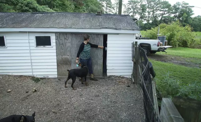 Amy Arthur opens the door to a small barn behind her home outside Mount Olive, N.C., on Monday, July 15, 2024. It was in this barn that her Army veteran husband, Chris, spoke with the government informant whose recording helped convict Arthur in federal court. (AP Photo/Allen G. Breed)