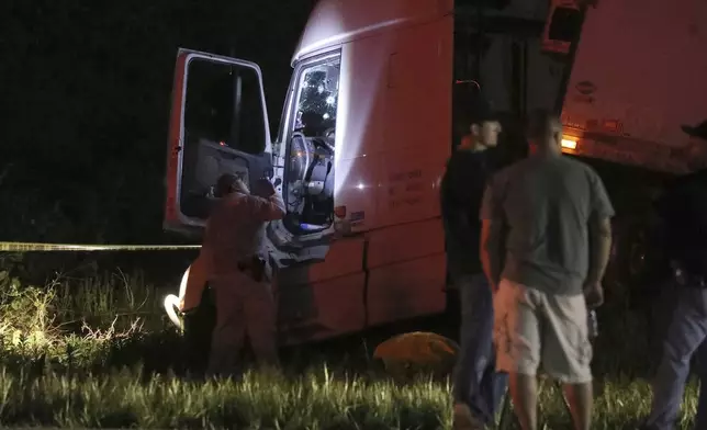 A Livingston County Sheriff investigator looks over the cab of a tractor trailer after driver Joshua Blessed was killed during a shootout with law enforcement officers on Rt. 20A in Geneseo, N.Y., on Wednesday, May 27, 2020. The incident started in LeRoy, N.Y., when police stopped the tractor trailer for speeding. Blessed took off and drove into Livingston County, leading law enforcement on a chase. (Tina MacIntyre-Yee/Democrat &amp; Chronicle via AP, File)