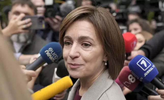 Moldova's President Maia Sandu speaks to the media after casting her vote in Chisinau, Moldova, Sunday, Oct. 20, 2024, during a presidential election and a referendum on whether to enshrine in the Constitution the country's path to European Union membership. (AP Photo/Vadim Ghirda)