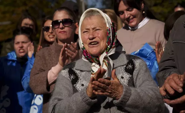 Supporters of Renato Usatii, leader of the Our Party and presidential candidate, applaud him during a rally on the final day of electoral campaign in Chisinau, Moldova, Friday, Oct. 18, 2024, ahead of a presidential election and a referendum on whether to enshrine in Moldova's Constitution its path to European Union membership that will take place on Oct. 20.(AP Photo/Vadim Ghirda)