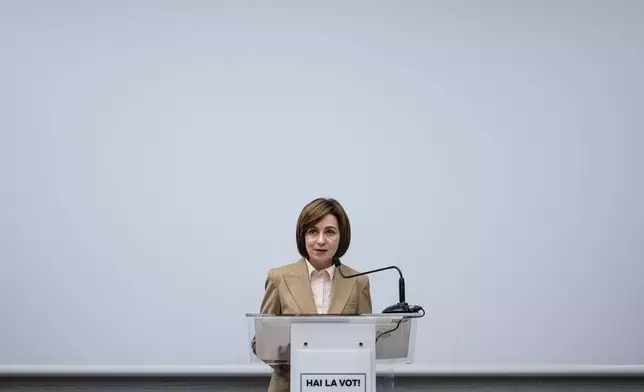 Moldova's President Maia Sandu speaks to the media during a press briefing after the polls closed for the presidential election and the referendum on whether to enshrine in the Constitution the country's path to European Union membership, in Chisinau, Moldova, early Monday, Oct. 21, 2024. (AP Photo/Vadim Ghirda)