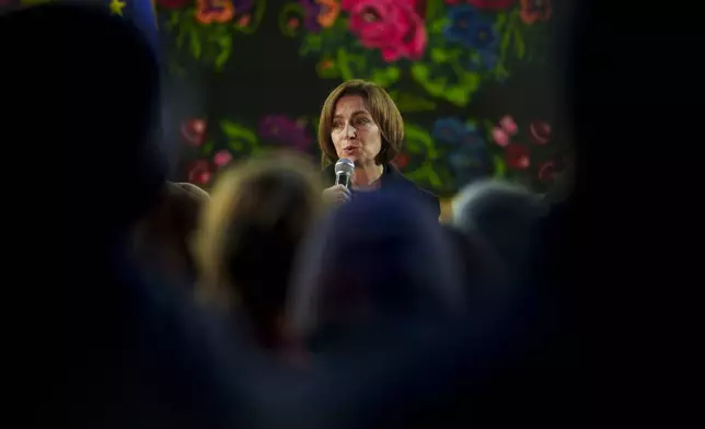 Moldova's President Maia Sandu speaks to people in Magdacesti, Moldova, Thursday, Oct. 17, 2024, as she seeks a second term in office ahead of a presidential election and a referendum of whether to enshrine in Moldova's Constitution its path to European Union membership taking place on Oct.20. (AP Photo/Vadim Ghirda)