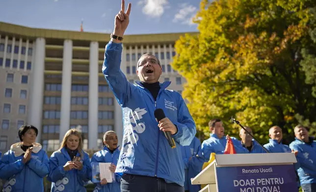 Renato Usatii, leader of the Our Party and presidential candidate, flashes the victory sign to supporters during a rally on the final day of electoral campaign in Chisinau, Moldova, Friday, Oct. 18, 2024, ahead of a presidential election and a referendum on whether to enshrine in Moldova's Constitution its path to European Union membership that will take place on Oct. 20.(AP Photo/Vadim Ghirda)