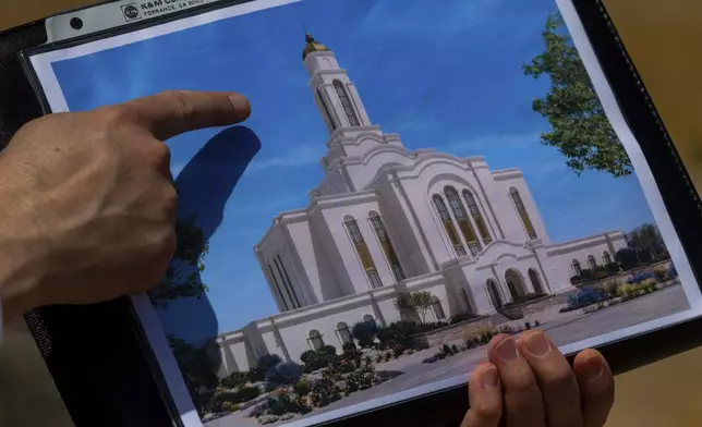 Bud Stoddard, a regional church leader, holds a rendering of the temple planned by The Church of Jesus Christ of Latter-day Saints at a site near Las Vegas, May 16, 2024. (AP Photo/Ty ONeil)