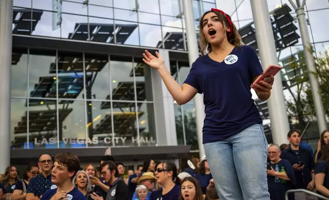 Members of The Church of Jesus Christ of Latter-day Saints sing outside Las Vegas City Hall as officials consider the church's plans to build a new temple near Las Vegas, May 14, 2024. (AP Photo/Ty ONeil)