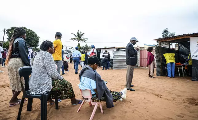 People queue to cast their votes during general elections in Maputo, Mozambique, Wednesday, Oct. 9, 2024. (AP Photo/Carlos Equeio)