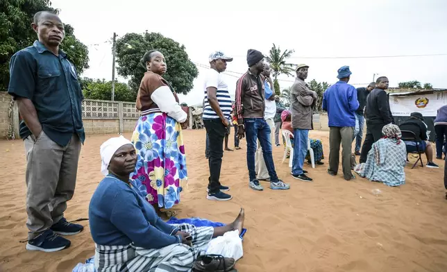 People queue to cast their votes during general elections in Maputo, Mozambique, Wednesday, Oct. 9, 2024. (AP Photo/Carlos Equeio)