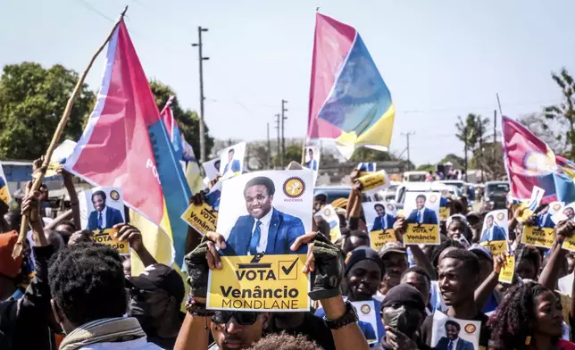 A poster of independent candidate Venacio Mondlane is held at an election rally on Sunday, Oct. 6, 2024 in Maputo ahead of elections in Mozambique. (AP Photo/Carlos Uqueio)