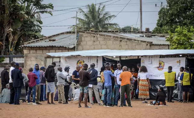 People queue to cast their votes during general elections in Maputo, Mozambique, Wednesday, Oct. 9, 2024. (AP Photo/Carlos Equeio)