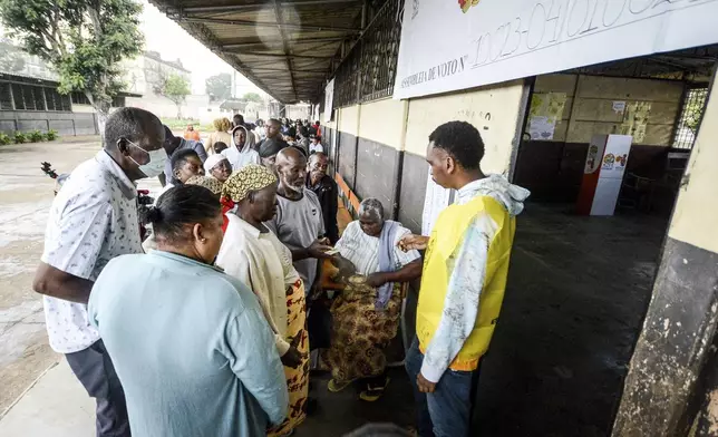 People queue to cast their votes during general elections in Maputo, Mozambique, Wednesday, Oct. 9, 2024. (AP Photo/Carlos Equeio)