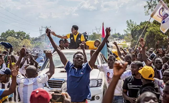 Independent candidate Venacio Mondlane, atop truck, attends an election rally in Maputo, Sunday, Oct. 6, 2024 ahead of elections to be held in Mozambique. (AP Photo/Carlos Uqueio)