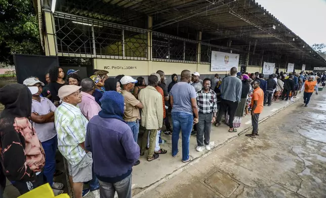 People queue to cast their votes during general elections in Maputo, Mozambique, Wednesday, Oct. 9, 2024. (AP Photo/Carlos Equeio)