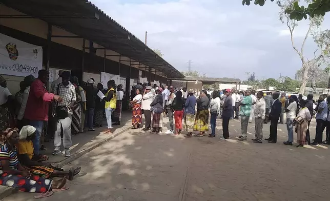 People queue to cast their votes during the general elections in Maputo, Mozambique, Wednesday, Oct. 9, 2024. (AP Photo/Charles Mangwiro)