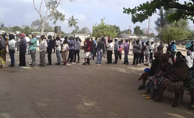 People queue to cast their votes during the general elections in Maputo, Mozambique, Wednesday, Oct. 9, 2024. (AP Photo/Charles Mangwiro)