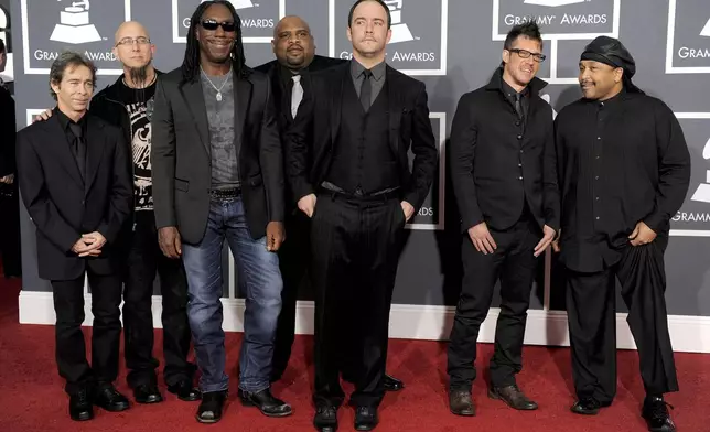 FILE - Members of the Dave Matthews Band, Tim Reynolds, Jeff Coffin, Boyd Tinsley, Rashawn Ross, Dave Matthews, Stefan Lessard and Carter Beauford arrive at the Grammy Awards in Los Angeles on Jan. 31, 2010. (AP Photo/Chris Pizzello, File)