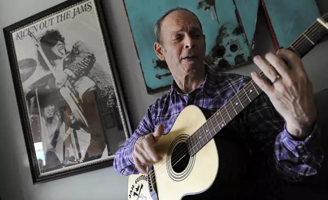 FILE - Wayne Kramer, co-founder of the protopunk Detroit band the MC5, plays a guitar at his recording studio in Los Angeles on Jan. 16, 2012. (AP Photo/Chris Pizzello, File)