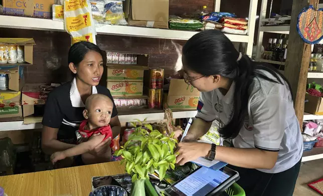 A census enumerator asks questions to a family member while collecting information to compile voter lists for a general election and to analyze population and socioeconomic trends, in Naypyitaw, Myanmar, Tuesday, Oct. 1, 2024. (AP Photo/Aung Shine Oo)