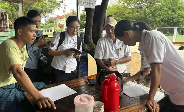 Census enumerators ask questions to a family member while collecting information to compile voter lists for a general election and to analyze population and socioeconomic trends, in Naypyitaw, Myanmar, Tuesday, Oct. 1, 2024. (AP Photo/Aung Shine Oo)