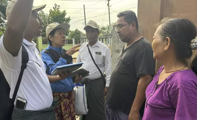 Census enumerators ask questions to family members while collecting information to compile voter lists for a general election and to analyze population and socioeconomic trends, in Naypyitaw, Myanmar, Tuesday, Oct. 1, 2024. (AP Photo/Aung Shine Oo)