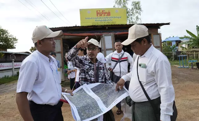 Census enumerators prepare to collect information from public in Naypyitaw, Myanmar Tuesday, Oct. 1, 2024 as the country holds a national census to compile voter lists for a general election and to analyze population and socioeconomic trends. (AP Photo/Aung Shine Oo)