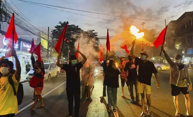 Pro-democracy protesters hold torches and flags during a flash mob rally to protest against Myanmar's military-government in Yangon, Myanmar on Sept.19, 2024. (Anti-Junta Alliance Yangon via AP)