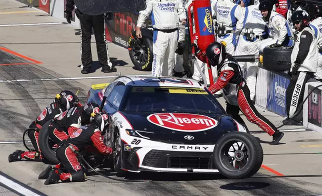 Christopher Bell (20) stops on pit road during a NASCAR Cup Series auto race at Kansas Speedway in Kansas City, Kan., Sunday, Sept. 29, 2024. (AP Photo/Colin E. Braley)