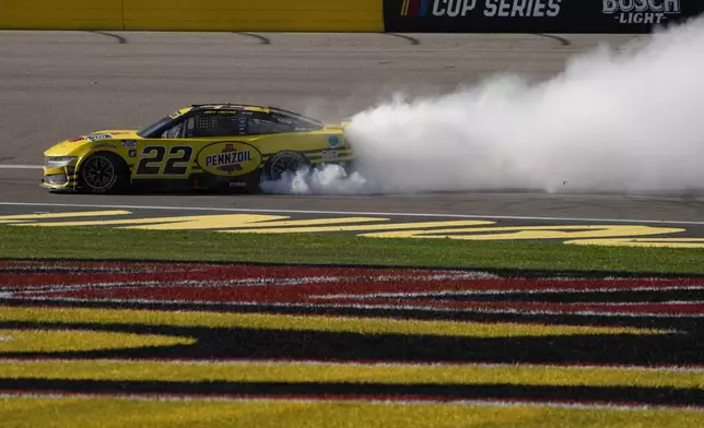 NASCAR Cup Series driver Joey Logano (22) does a burnout after winning a NASCAR Cup Series auto race Sunday, Oct. 20, 2024, in Las Vegas. (AP Photo/John Locher)