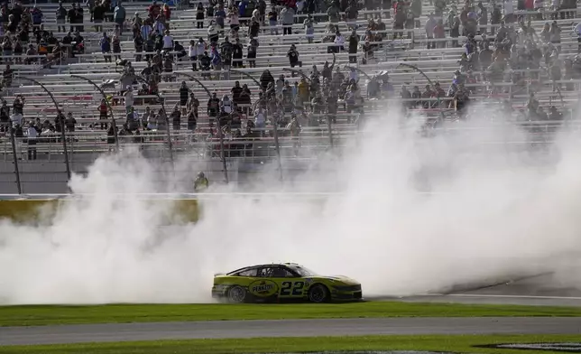 NASCAR Cup Series driver Joey Logano (22) does a burnout after winning a NASCAR Cup Series auto race Sunday, Oct. 20, 2024, in Las Vegas. (AP Photo/John Locher)