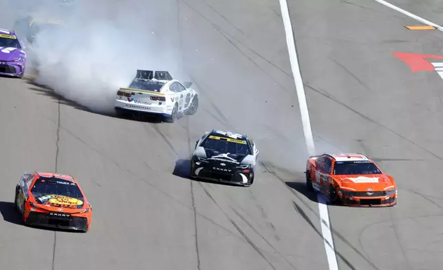 NASCAR Cup Series drivers Chase Elliott (9) Tyler Reddick (45) and Brad Keselowski (6) slide across the front straightaway after a crash during a NASCAR Cup Series auto race at the Las Vegas Motor Speedway Sunday, Oct. 20, 2024, in Las Vegas. (Steve Marcus/Las Vegas Sun via AP)