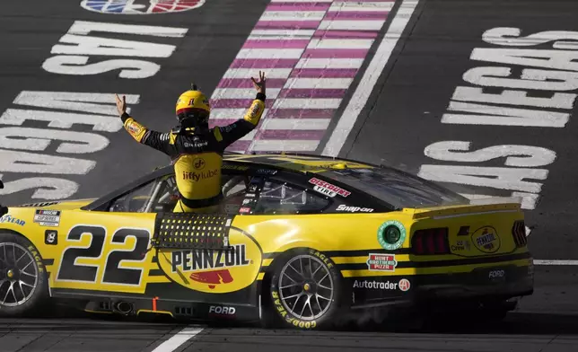 NASCAR Cup Series driver Joey Logano (22) celebrates after winning a NASCAR Cup Series auto race Sunday, Oct. 20, 2024, in Las Vegas. (AP Photo/John Locher)