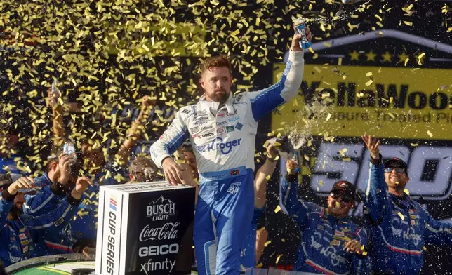 Driver Ricky Stenhouse Jr. celebrates in Victory Lane after a NASCAR Cup Series auto race at Talladega Superspeedway, Sunday, Oct. 6, 2024, in Talladega, Ala. (AP Photo/ Butch Dill)