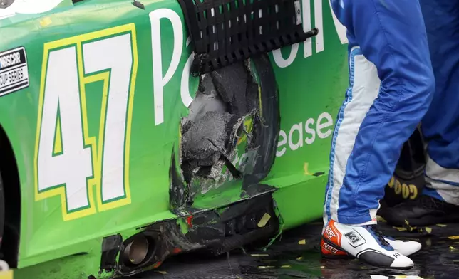 Driver Ricky Stenhouse Jr.'s car shows damage from a wreck in the last few laps of a NASCAR Cup Series auto race at Talladega Superspeedway, Sunday, Oct. 6, 2024, in Talladega, Ala. (AP Photo/ Butch Dill)